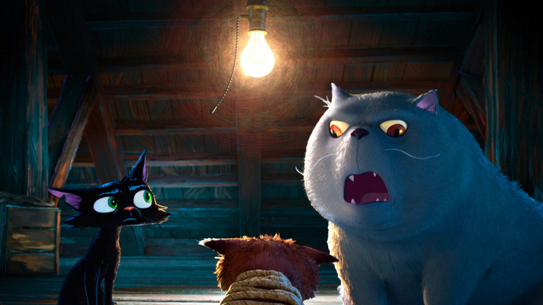 Nero (Mark Ruffalo) and a larger cat interrogate a tied up cat in an attic in Gatto