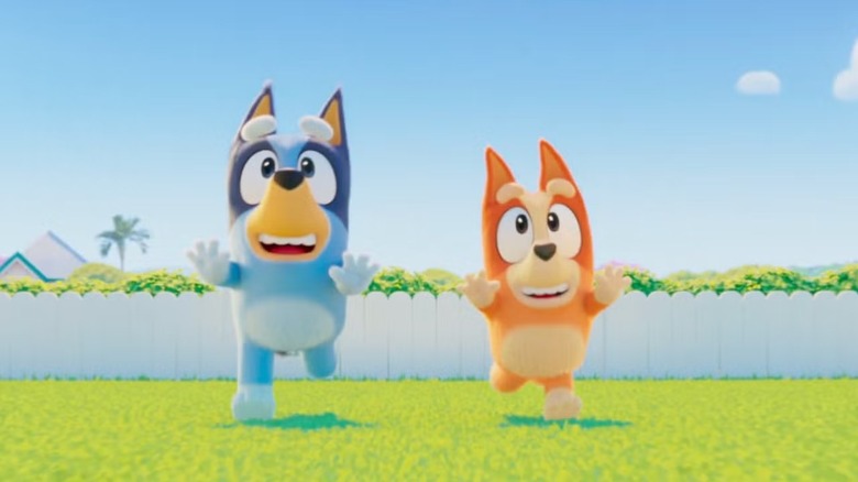 Bluey and Bingo runs through their yard in The Bluey Movie