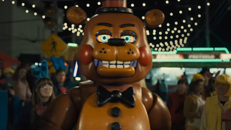 Freddy Fazbear in Five Nights at Freddy's 2, walking through a crowd of people at a carnival.