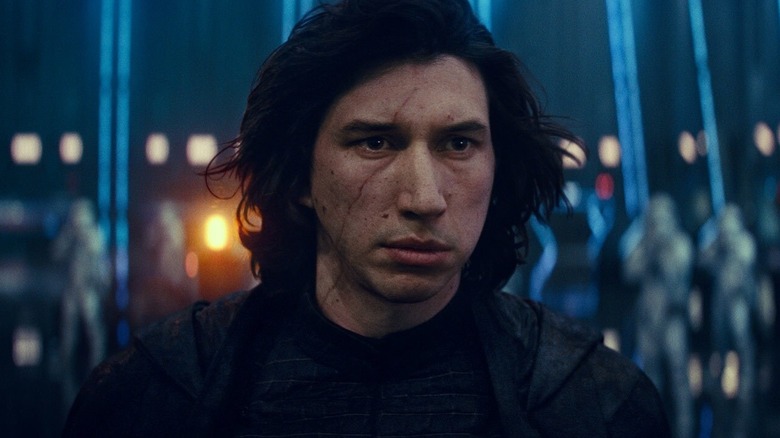 Adam Driver as Kylo Ren with his helmet off standing in front of stormtroopers in Star Wars: The Rise of Skywalker