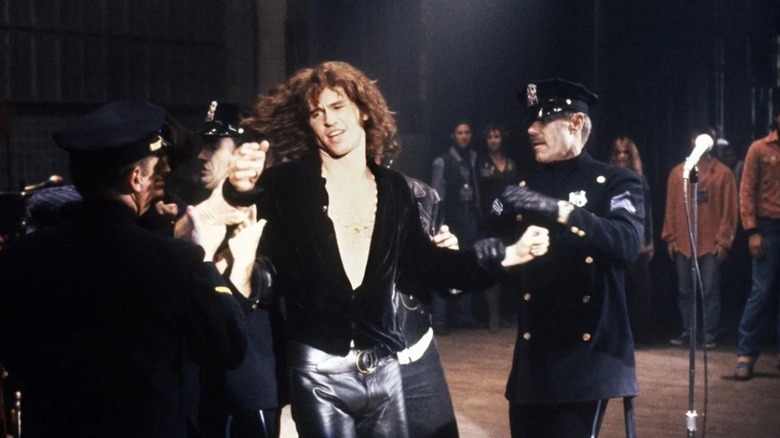 Val KIlmer is hauled off by police as Jim Morrison in The Doors