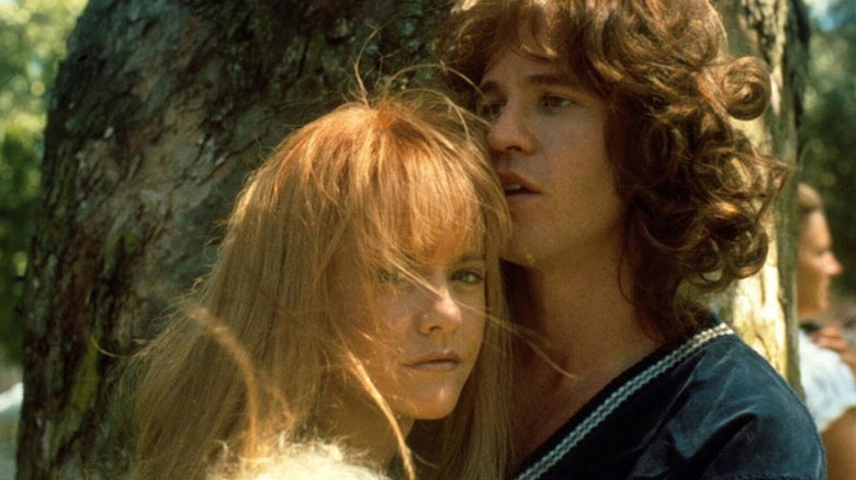 Meg Ryan as Pamela Courson embraces Val Kilmer as Jim Morrison in The Doors
