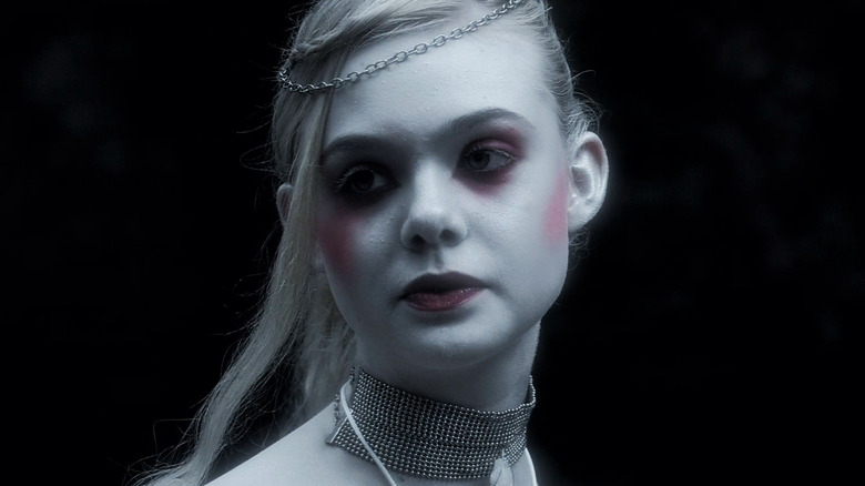 Elle Fanning's V is seen in closeup against a black background V in Twixt
