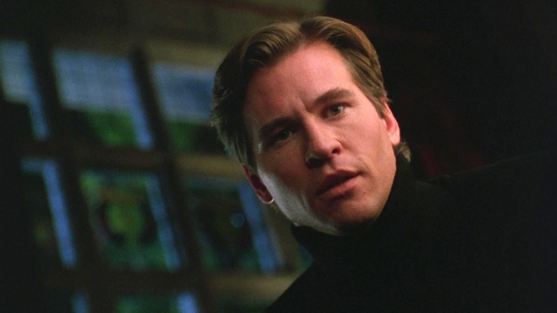 Val Kilmer's Bruce Wayne looks worried in closeup in Batman Forever