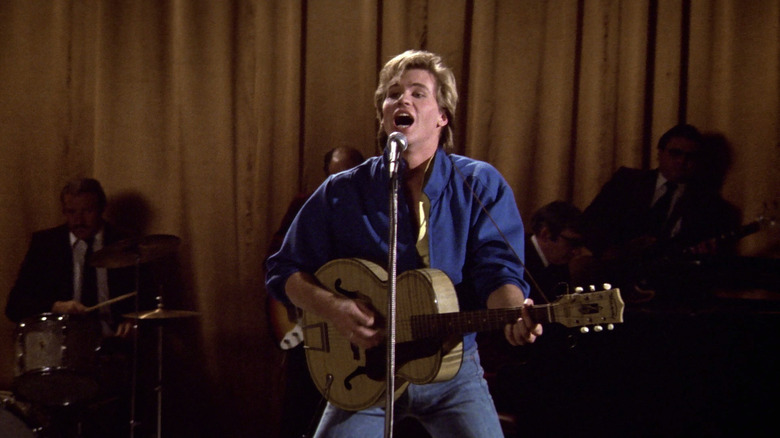 Val Kilmer as Nick Rivers singing and playing guitar in Top Secret!