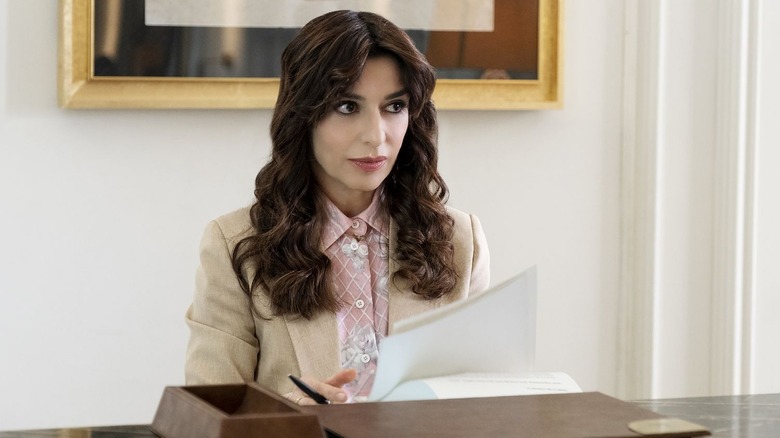 Valentina looking up ominously from behind her desk in The White Lotus