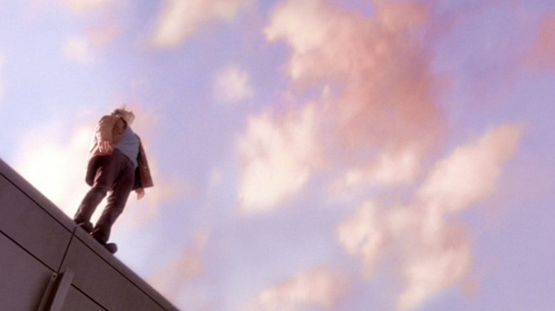 Tom Cruise as David Aames preparing to leap from a rooftop at the end of Vanilla Sky