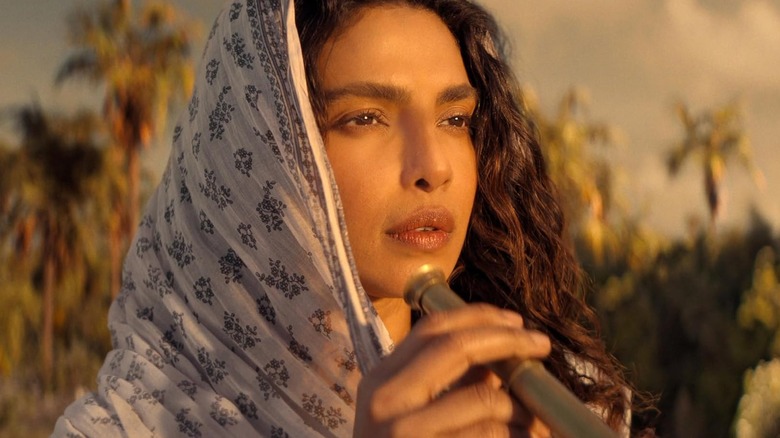 Priyanka Chopra Jonas as Ercell Bodden holding a telescope in The Bluff