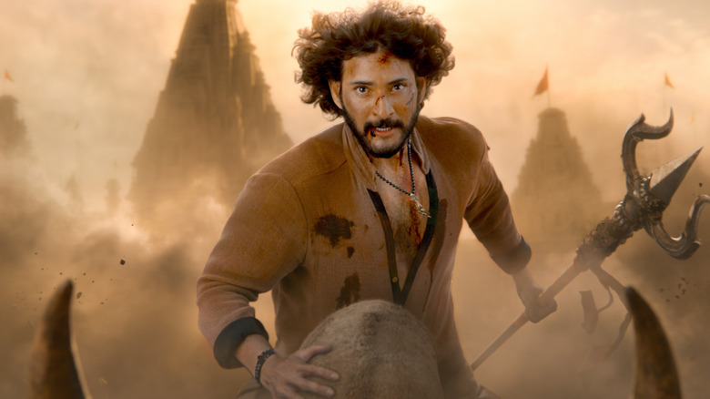 Mahesh Babu as Rudhra riding atop a giant animal and holding a spear in Varanasi