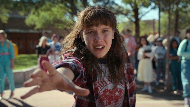 Millie Bobby Brown's Eleven holding her hand out in Stranger Things season 4