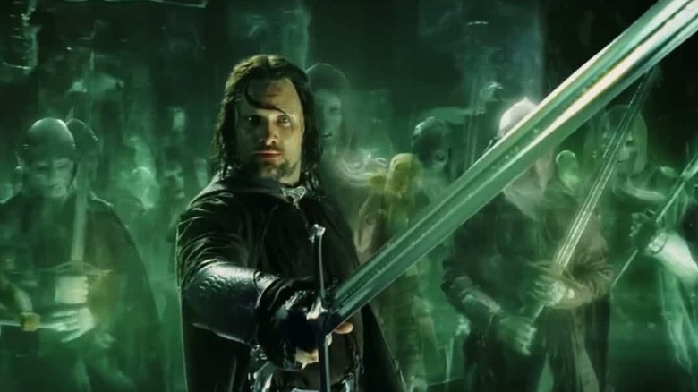 Aragorn (Viggo Mortensen) holding sword surrounded by the Army of the Dead in "The Return of the King"