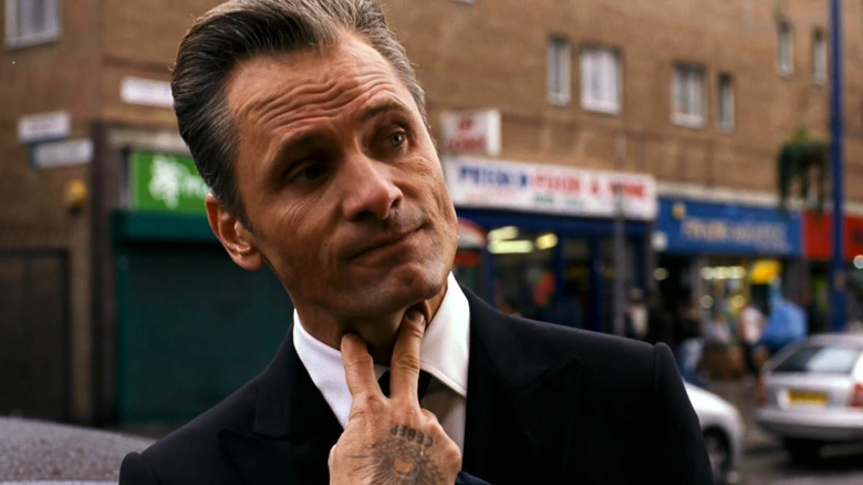 Nikolai pointing his fingers to his neck in Eastern Promises