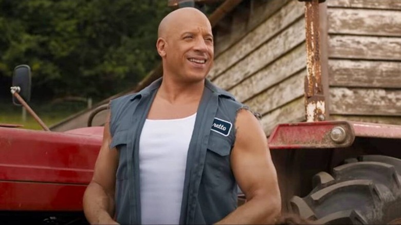 F9 dom in vest and tank smiling