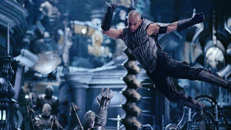 Vin Diesel as Riddick flying through the air with a knife in The Chronicles of Riddick