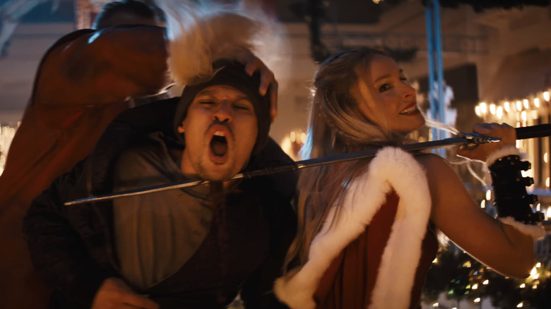 Kristen Bell and David Harbour as Mrs. Claus and Santa Claus, dispatching with a bad guy in Violent Night 2