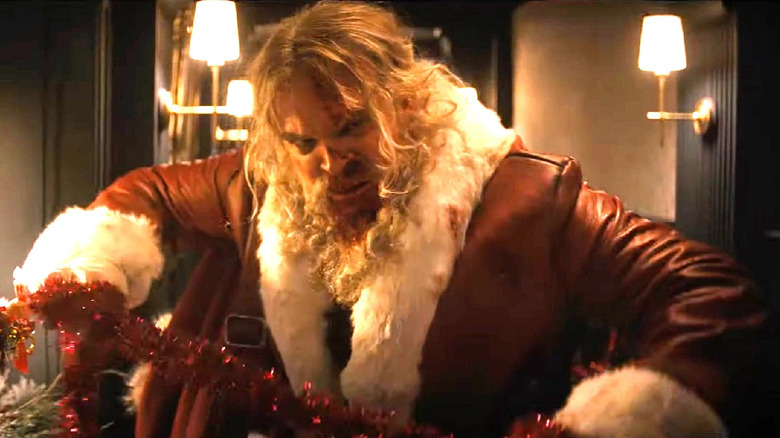 Violent Night santa with festive garrote