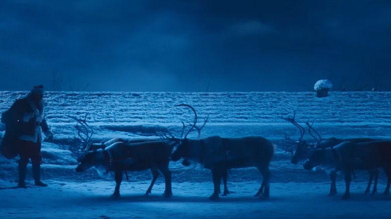 Violent Night santa on roof with reindeer