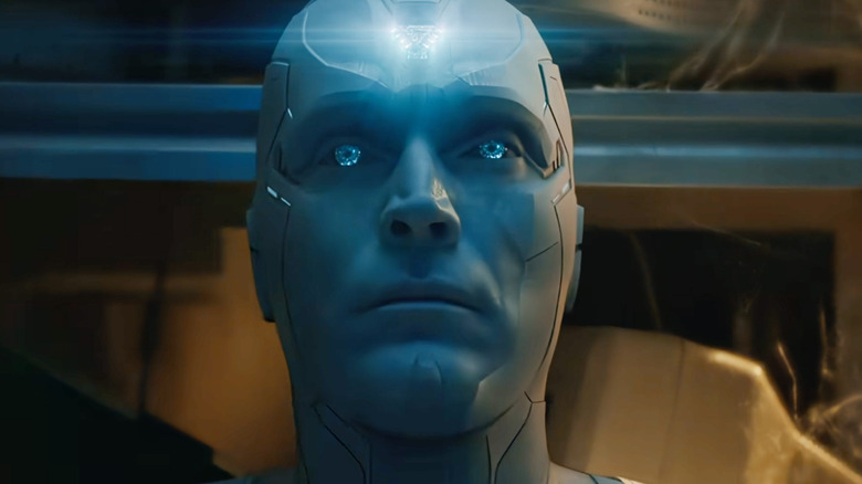 Paul Bettany as White Vision sitting in a broom closet with a glowing icon on his forehead in VisionQuest