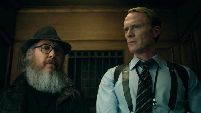 James Spader as Ultron wearing a top hat standing next to Paul Bettany as Vision in their human avatars in VisionQuest