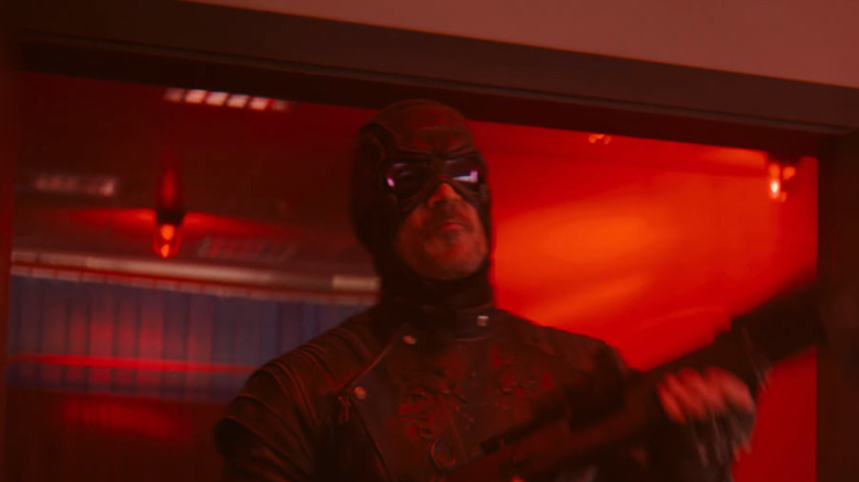 Todd Stashwick as Paladin coming through a doorway with a gun in his hand in VisionQuest