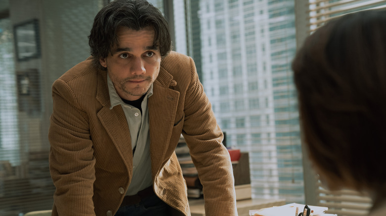 Wagner Moura leaning over a desk in Shining Girls