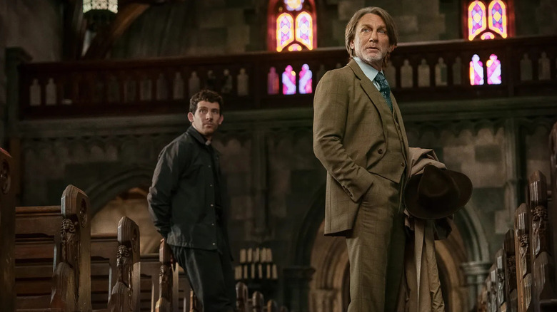 Jud and Blanc in the church looking over at someone in Wake Up Dead Man