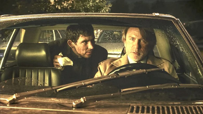 Wake Up Dead Man: A Knives Out Mystery, Father Jud and Benoit Blanc in Blanc's car at night