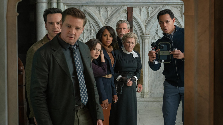 Lee Nat Simone Vera Samson Matilda and Cy looking through a doorway shocked in Wake Up Dead Man