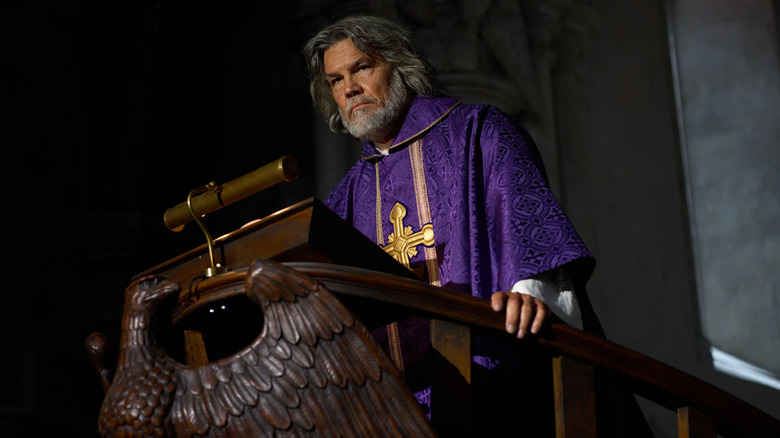 Jefferson scowling at his pulpit looking at the constituents in Wake Up Dead Man: A Knives Out Mystery