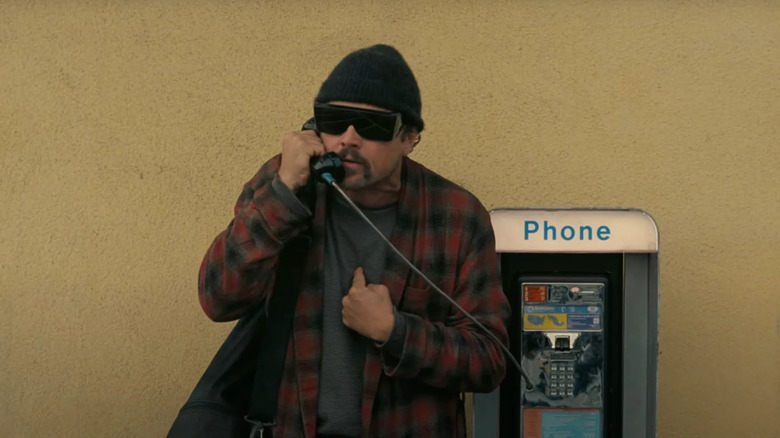 Leonardo DiCaprio uses a payphone as Bob Ferguson in One Battle After Another