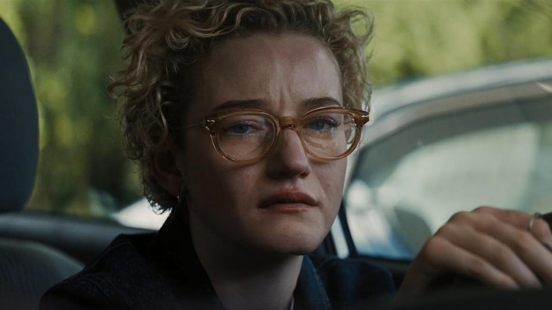Julia Garner as Justine looking distressed in her car in Weapons