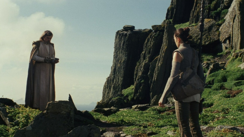 Rey presenting Luke with a lightsaber in Star Wars: The Last Jedi
