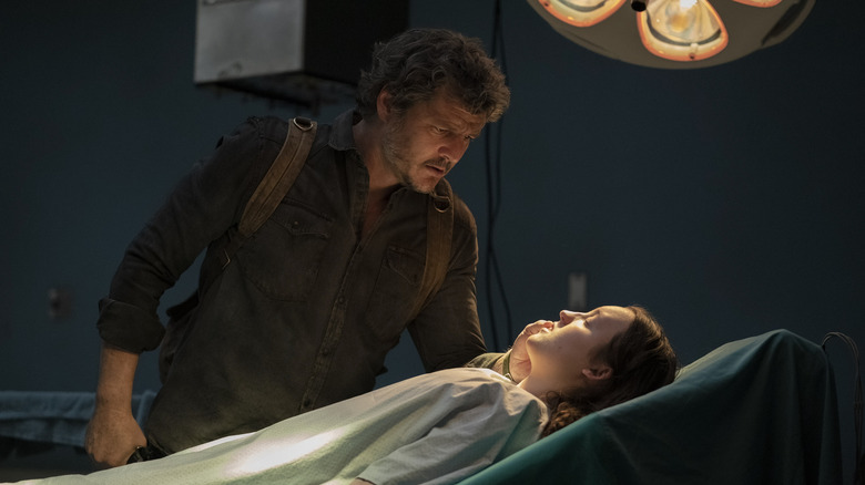 Joel looking at Ellie on the operating table in The Last of Us