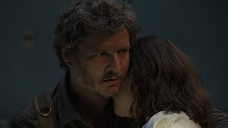 Joel holding an unconscious Ellie on The Last of Us