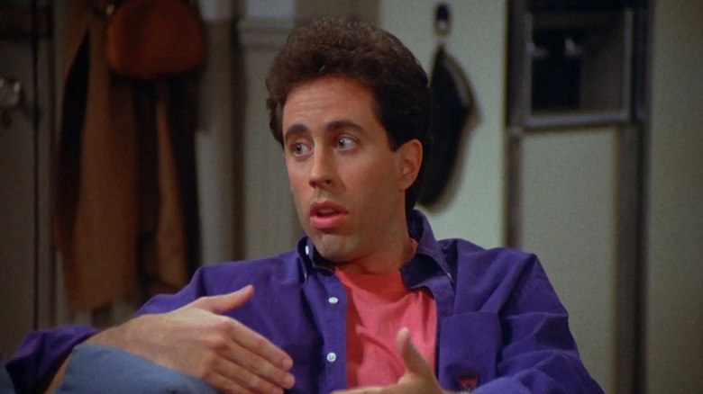 Jerry Seinfeld making a gesture with his hands on Seinfeld