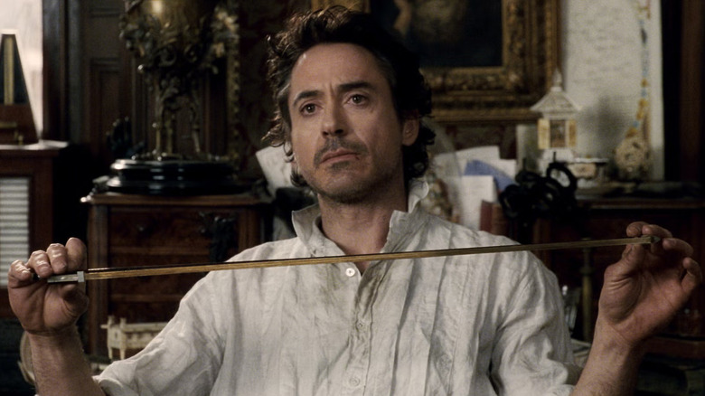 Sherlock Holmes holding a violin bow