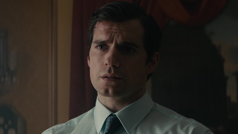 Napoleon Solo Henry Cavil carries a shirt and tie in uncle's man