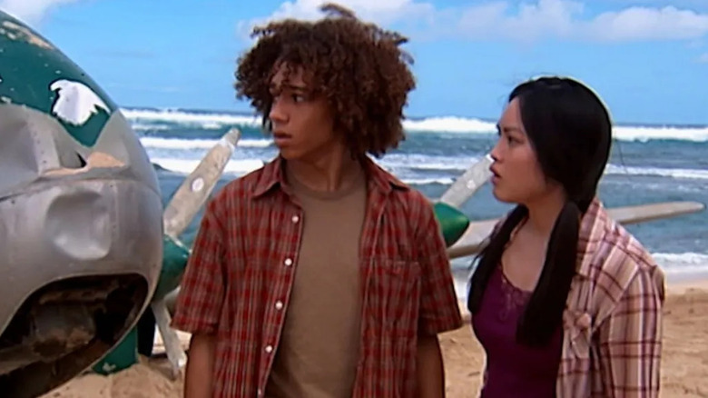 Nathan and Melissa looking at a downed plane on a beach in Flight 29 Down