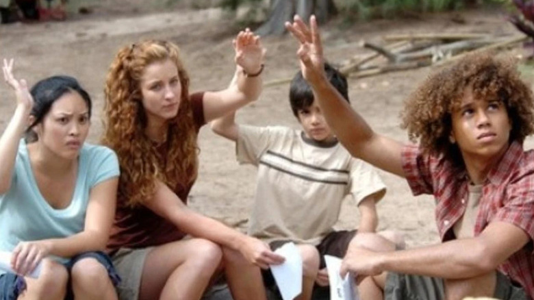Melissa, Hailee, Lex, and Nathan all raising their hands on Flight 29 Down