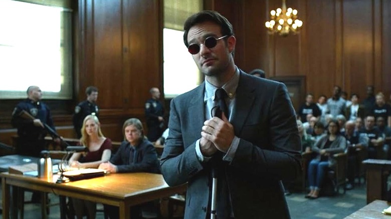 Matt Murdock in court with his hands gripping his cane in Daredevil (2015)