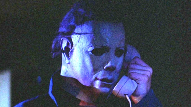 Michael Myers (Nick Castle) holding a telephone in 