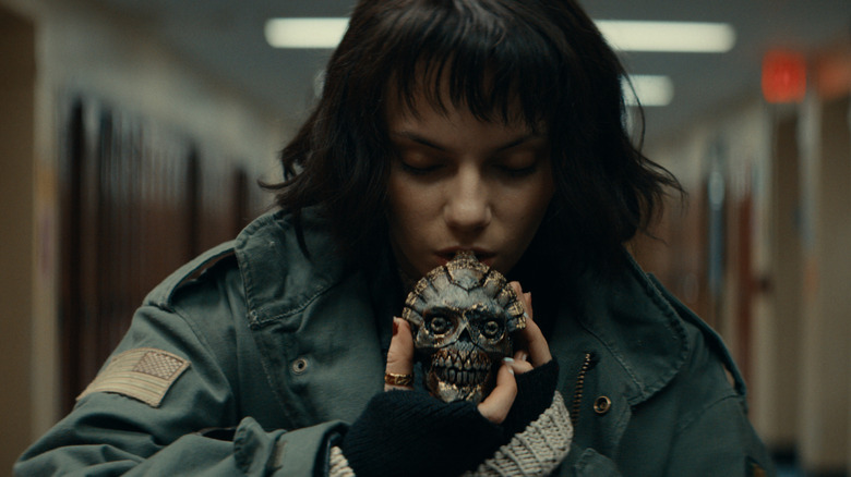 Chrys putting the whistle to her mouth in Whistle