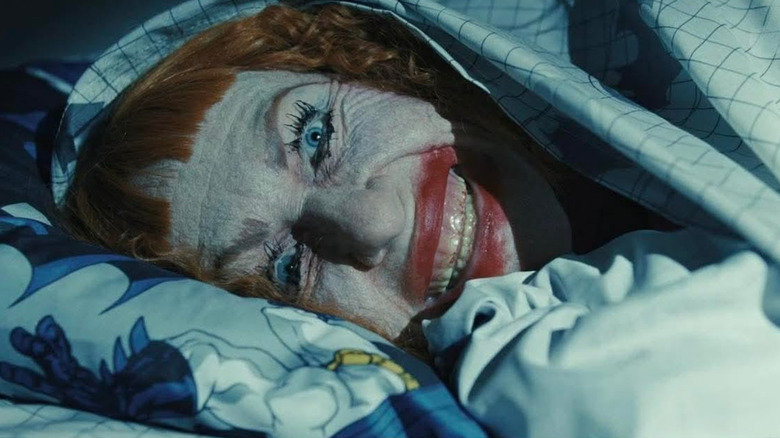 Aunt Gladys grins scarily under a Batman duvet in Weapons