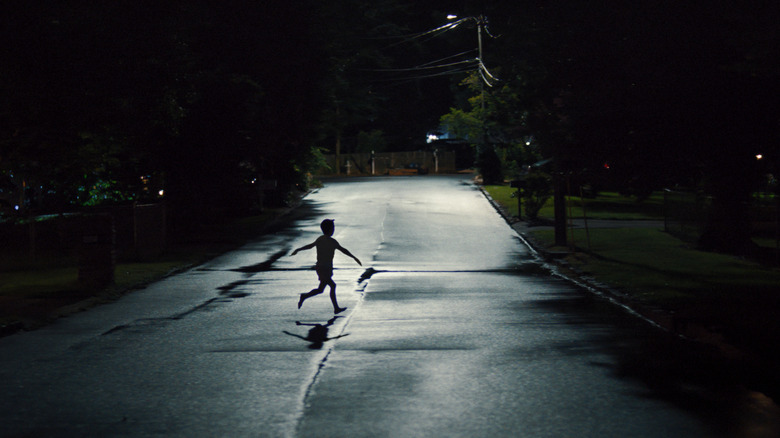 A child running across the street at night in Weapons