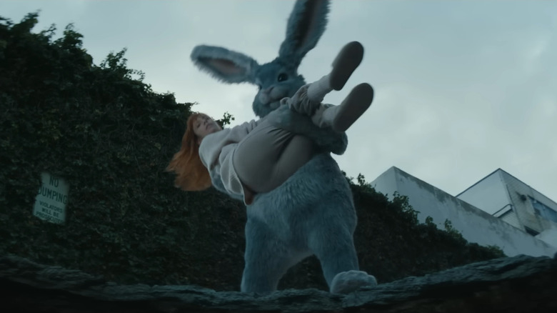 Huge rabbit about to sacrifice someone to the rabbit hole in Tubi advertisement 