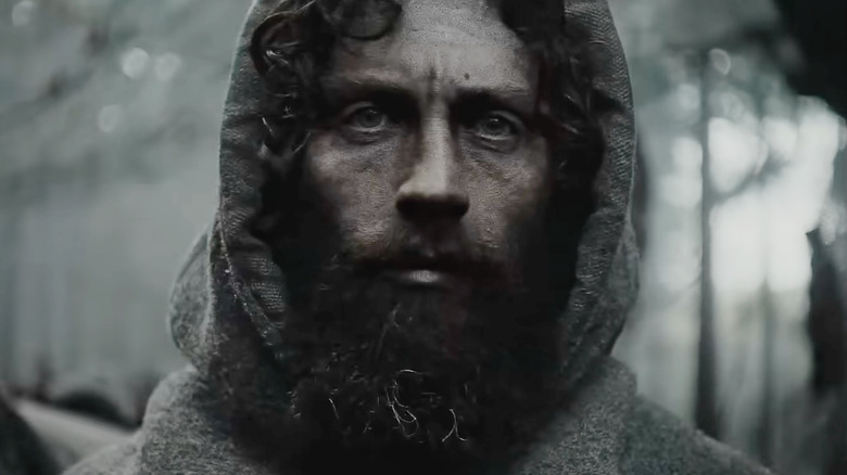 The farmer looking solemn while wearing a hood in Werwulf