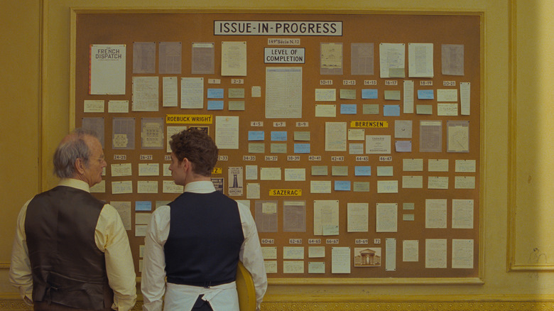 Bill Murray and Pablo Pauly stand in front of the issue-in-progress board in The French Dispatch