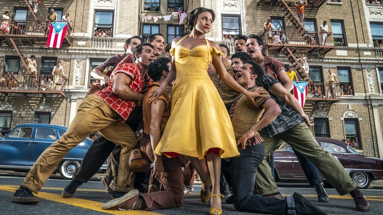 Yellow dress woman, men surrounding