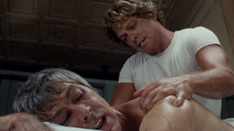 Dr. Peter Carey getting a massage from Roger Hudson in The Carey Treatment