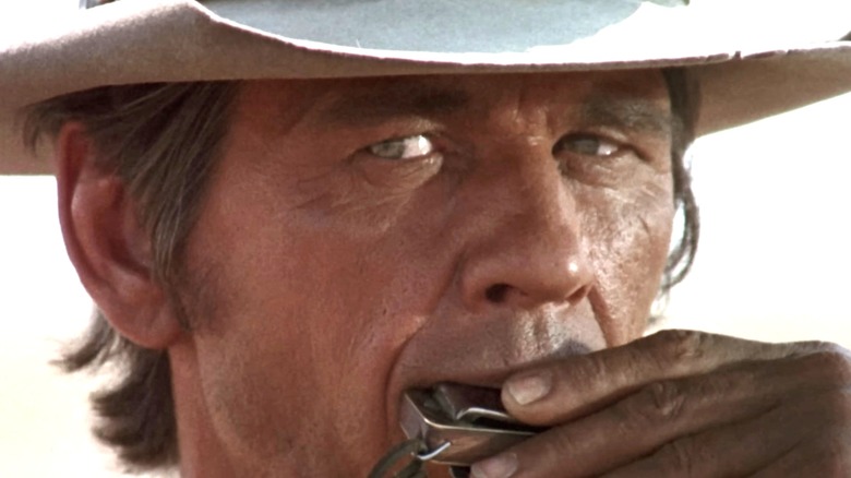 Charles Bronson's Harmonica plays his Harmonica in closeup in Once Upon a Time in the West